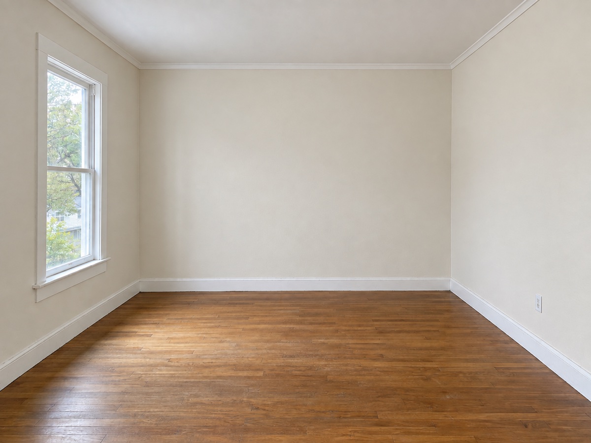 After painting: freshly painted walls with the same window and wooden floor